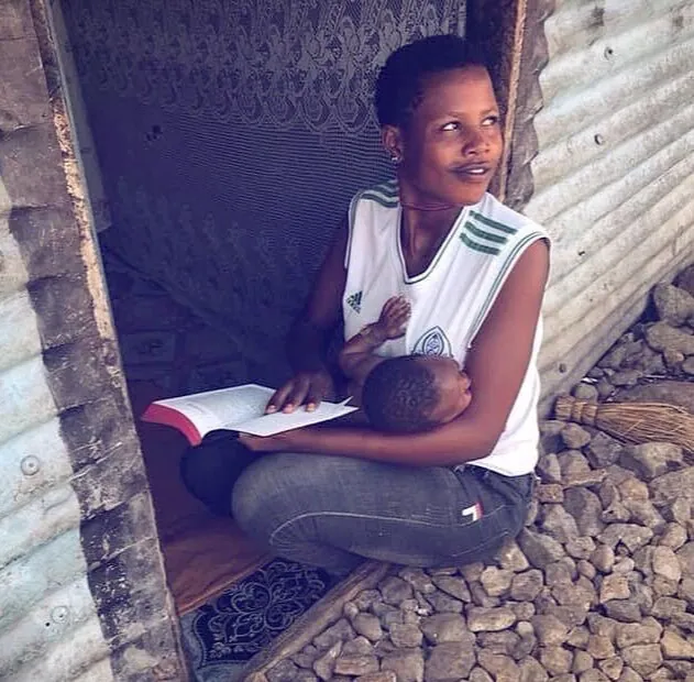 A young woman reading her Bible on the church steps